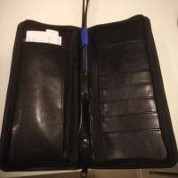 Equestrian leather travel wallet with retractable strap