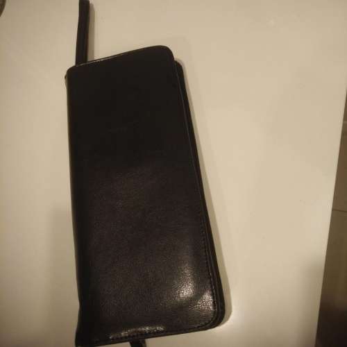 Equestrian leather travel wallet with retractable strap