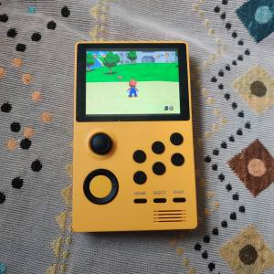 Yellow Handheld Game Station with Pandora Games Mini system.