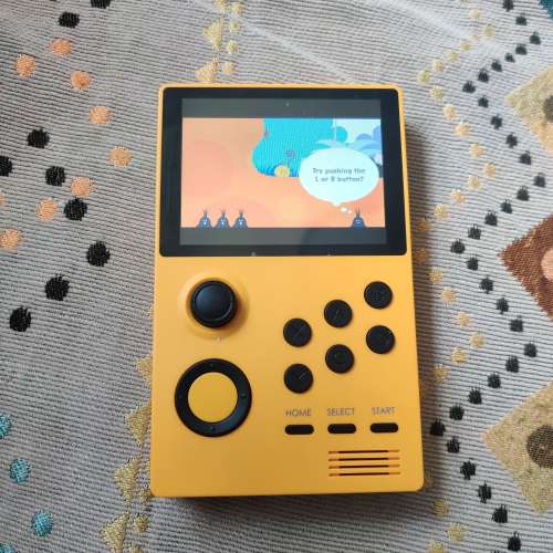 Yellow Handheld Game Station with Pandora Games Mini system.