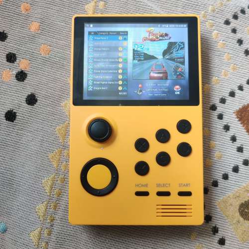 Yellow Handheld Game Station with Pandora Games Mini system.