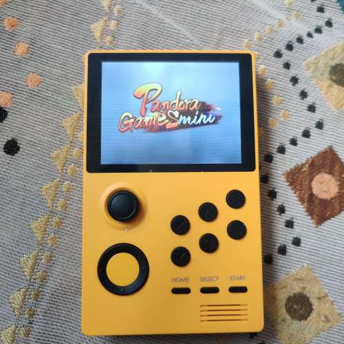 Yellow Handheld Game Station with Pandora Games Mini system.